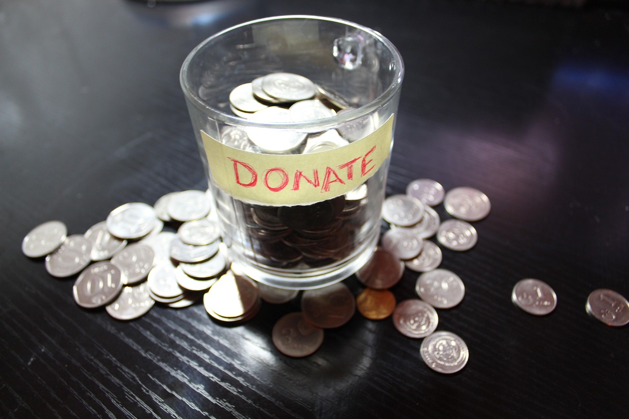 Pot de dons rempli de pièces de monnaie pour collecter des fonds pour association